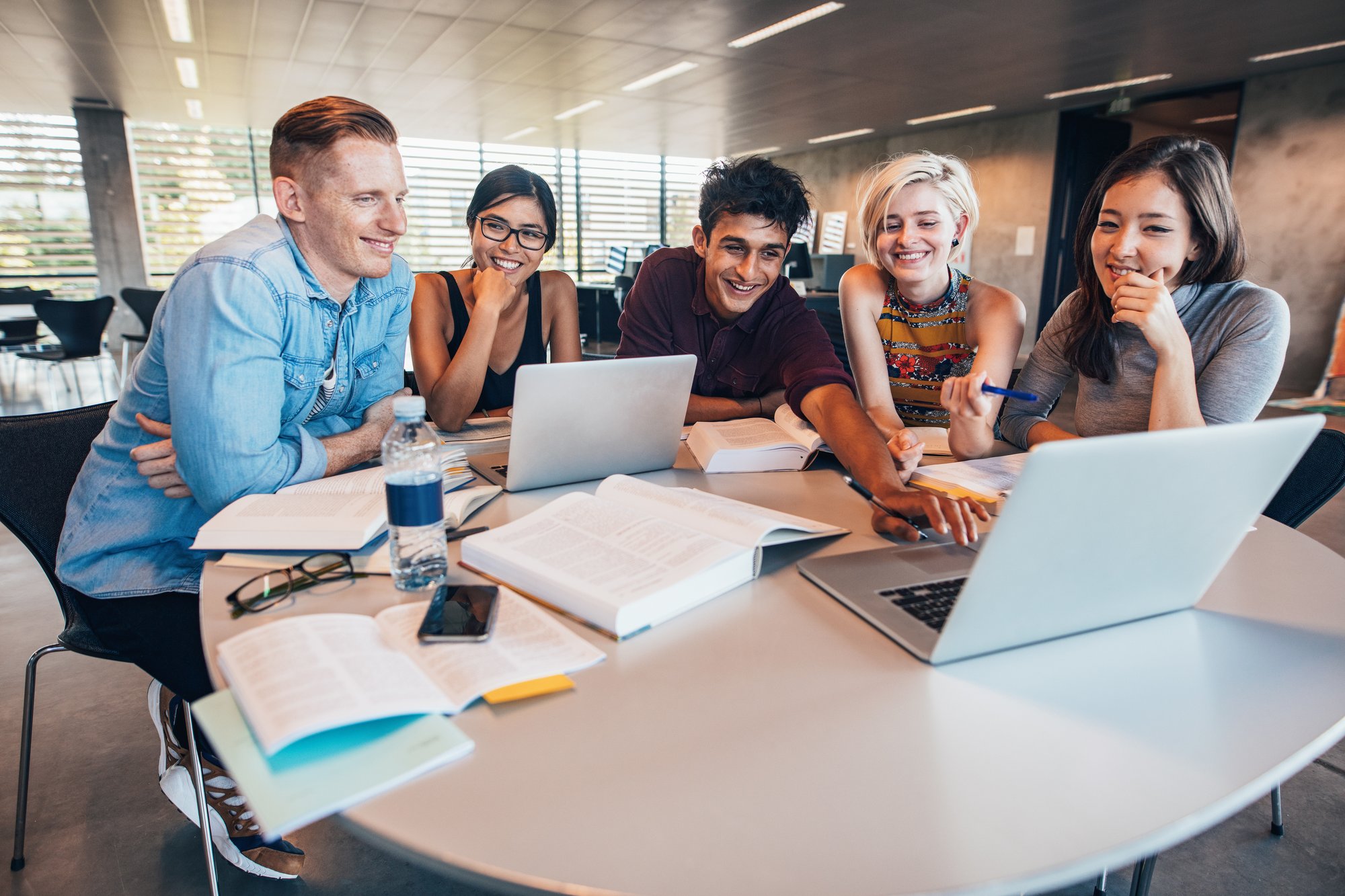 Students sat around a table having a conversation