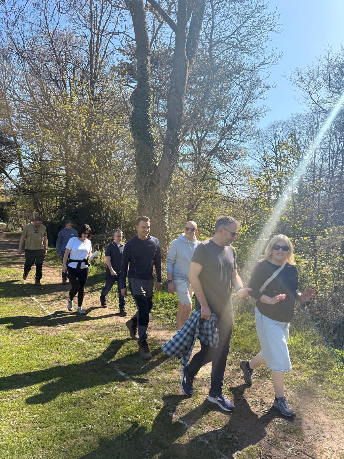 A group of adults walking on a sunny day