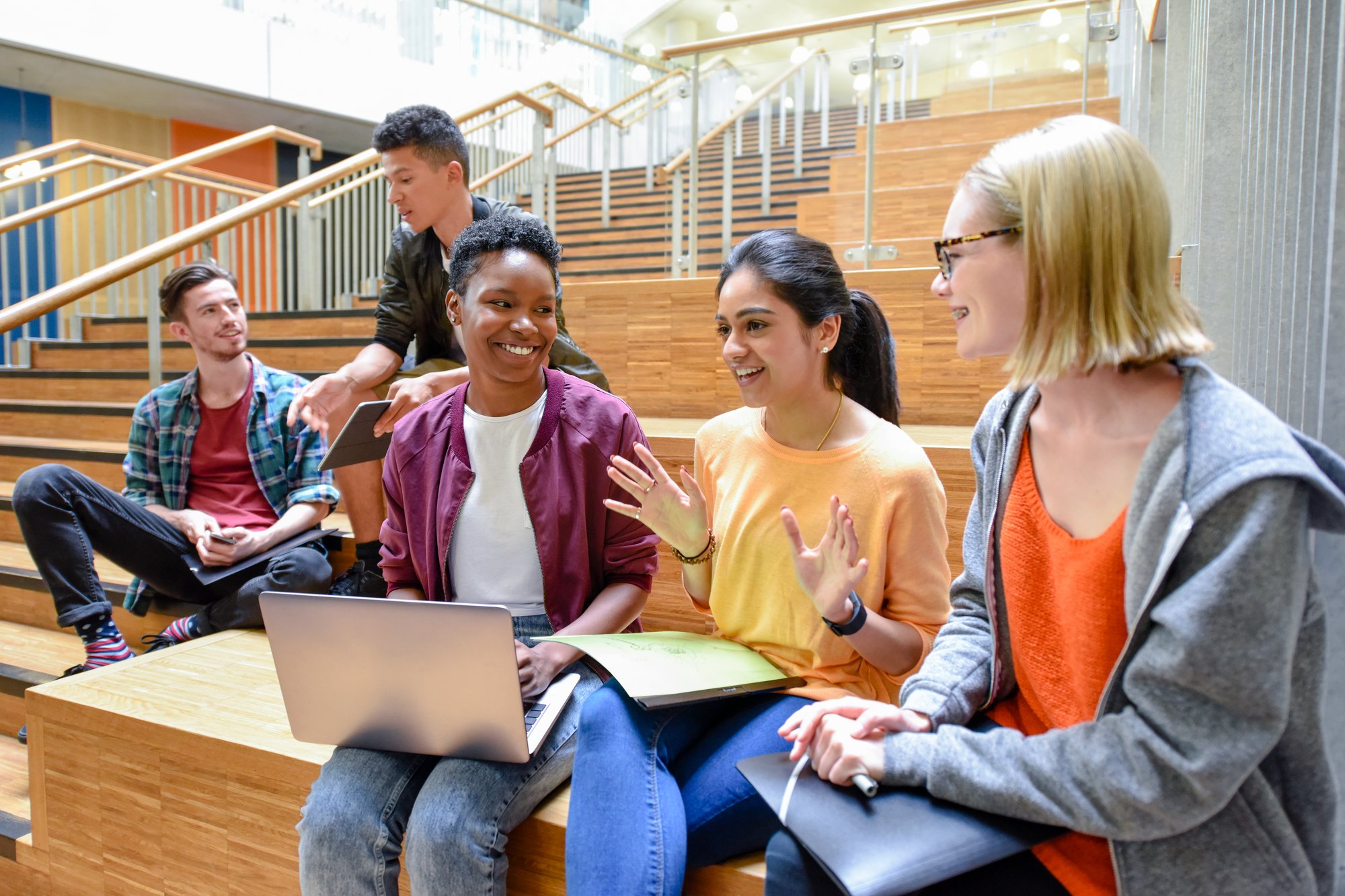 A group of students sat on some steps talking