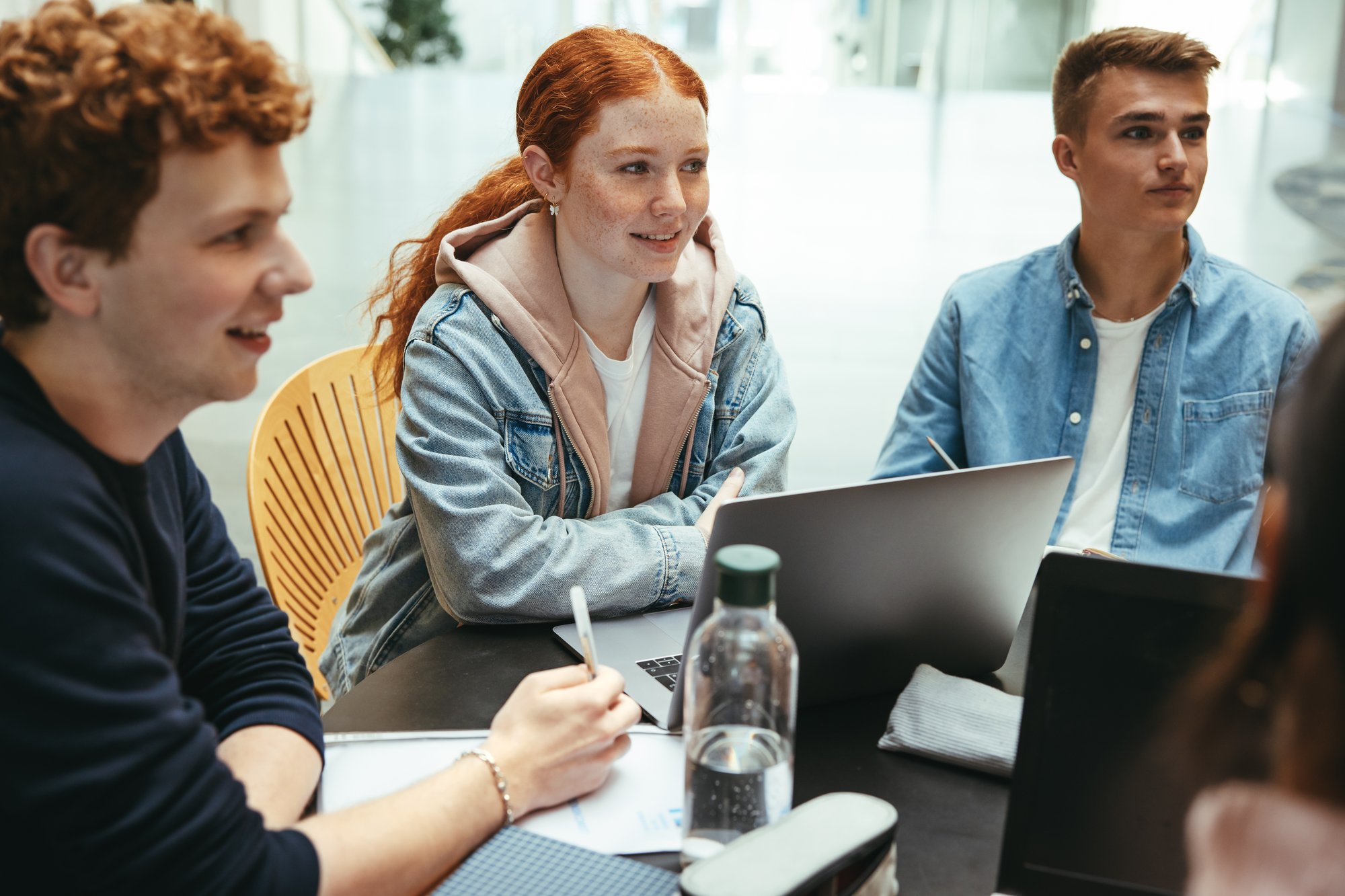 Students sat around a table studying