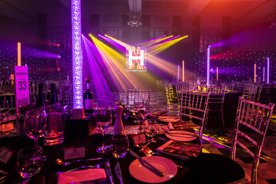 The Heist Awards ceremony - tables set up for dinner in front of a stage